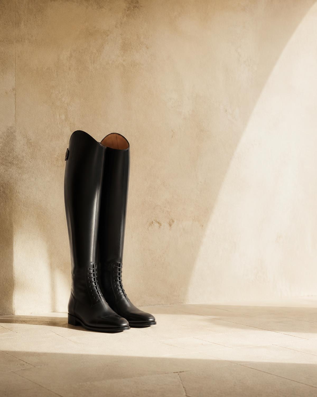 A pair of tall black riding boots